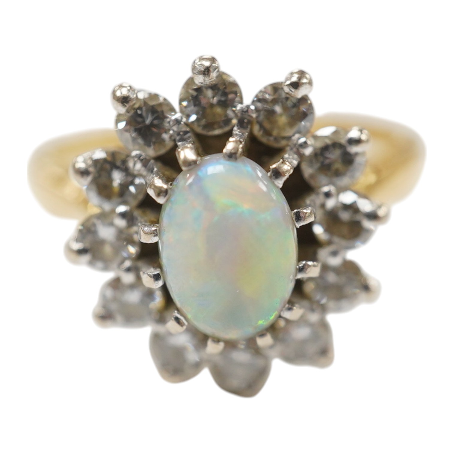 A modern 18ct gold, white opal and diamond set oval cluster ring, size M/N, gross weight 4.6 grams, the opal weighing approximately 0.50ct, total diamond weight approx. 0.48ct. Condition - fair to good